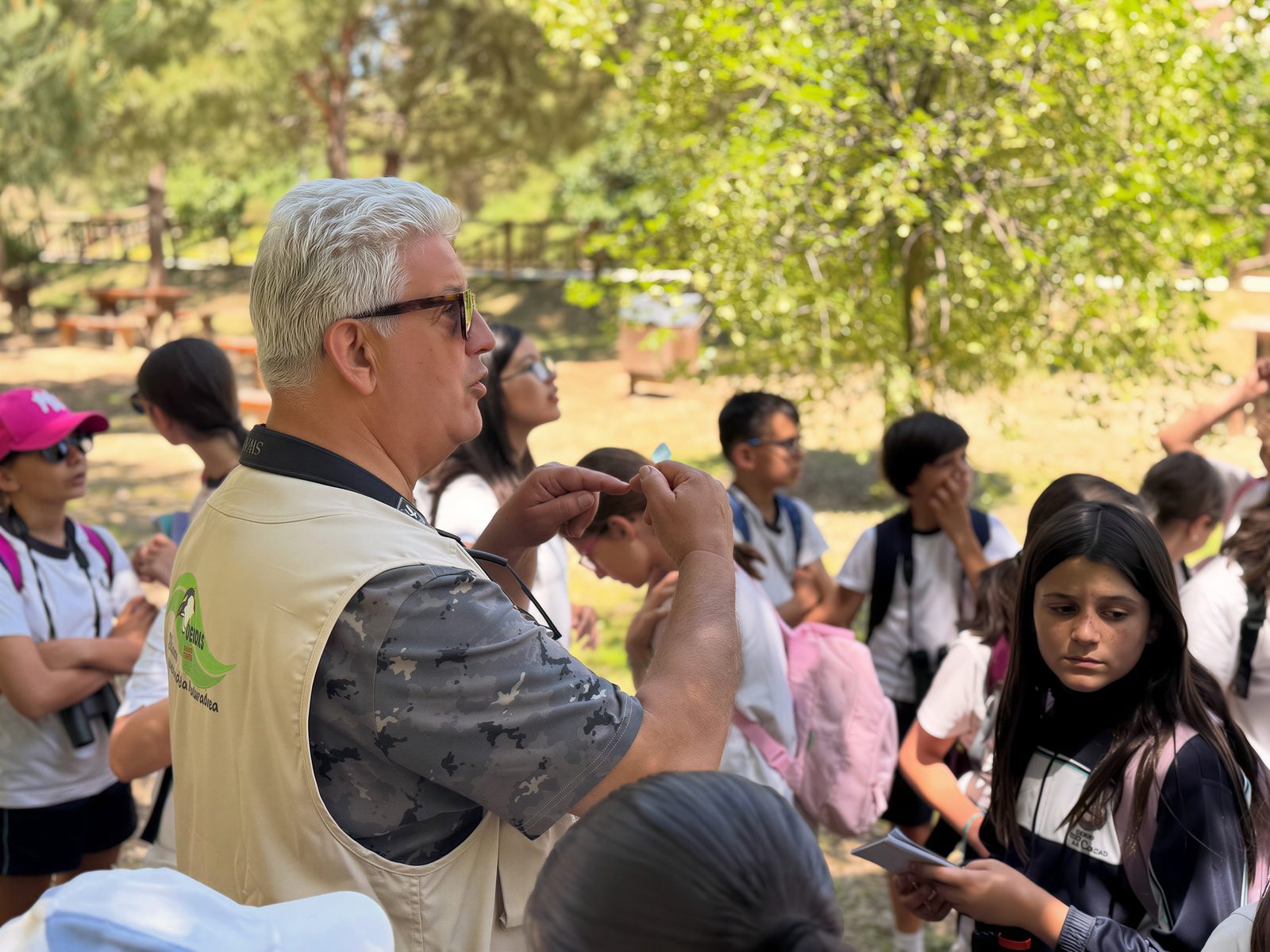 Monitor explicando al alumnado durante una actividad de educación ambiental